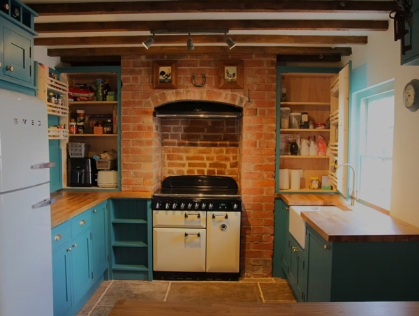 modern kitchen with wooden countertops and turquoise cabinets featuring a brick wall stove and open shelves for storage 3 essential kitchen items organized