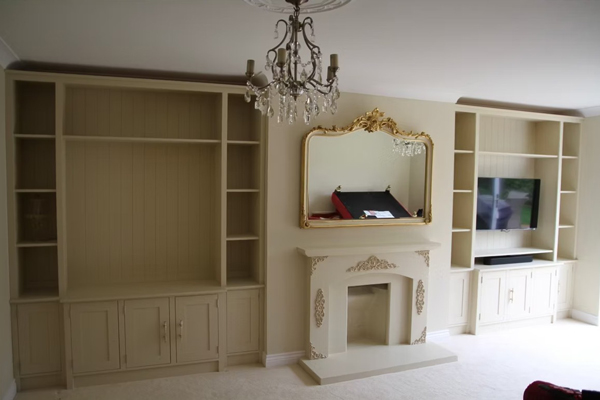 elegantly designed living room with a decorative chandelier television unit and stylish fireplace featuring two built-in shelves and a large mirror